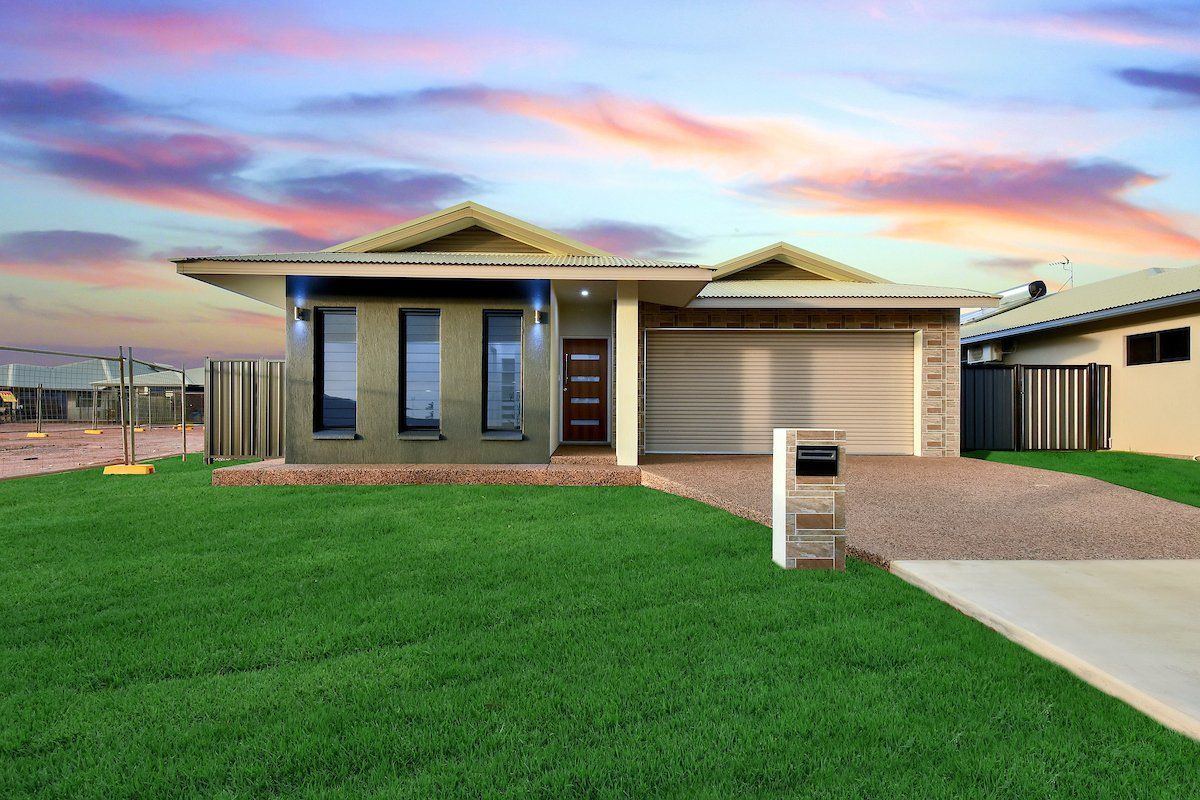A house with a large lawn in front of it.