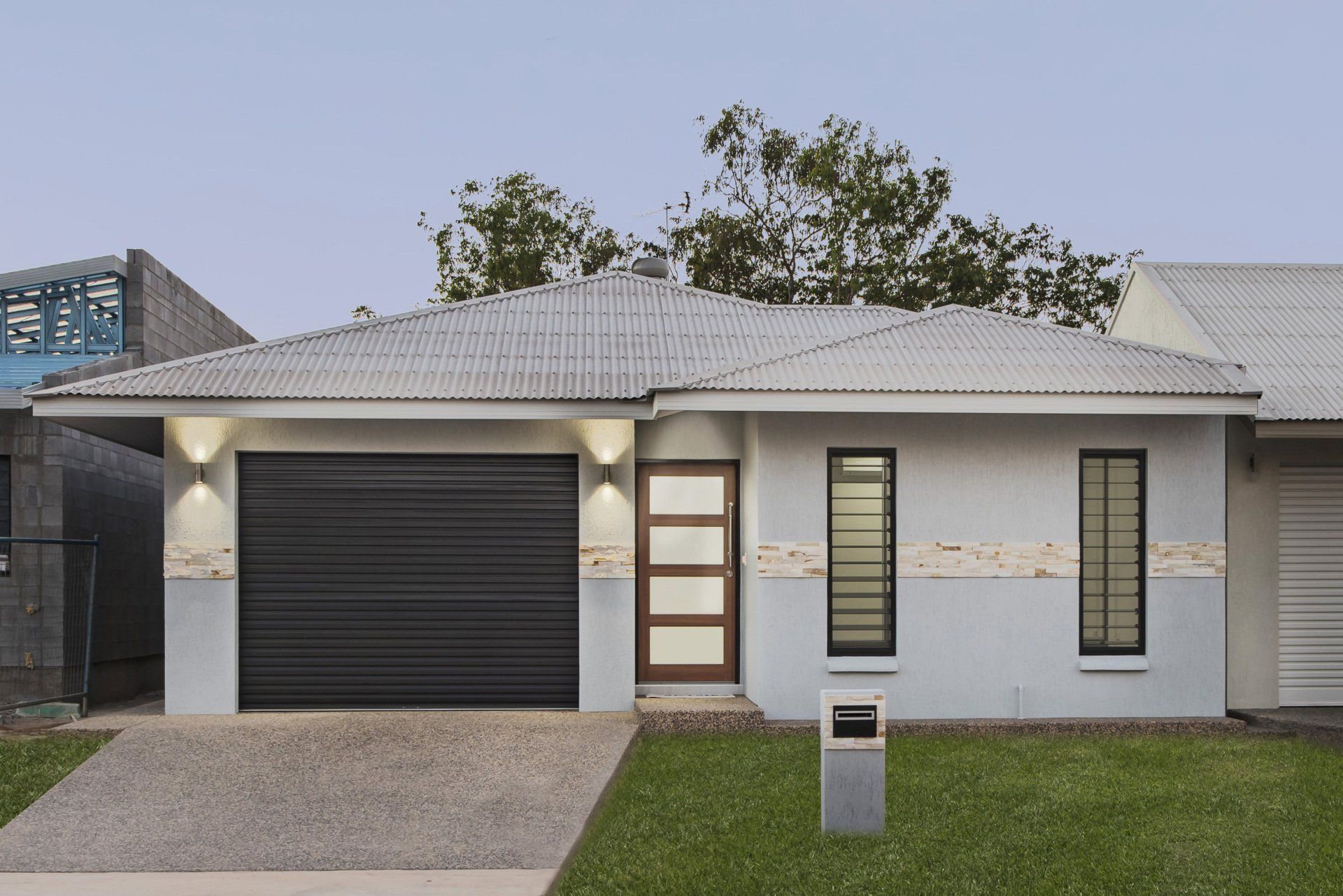 A white house with a black garage door
