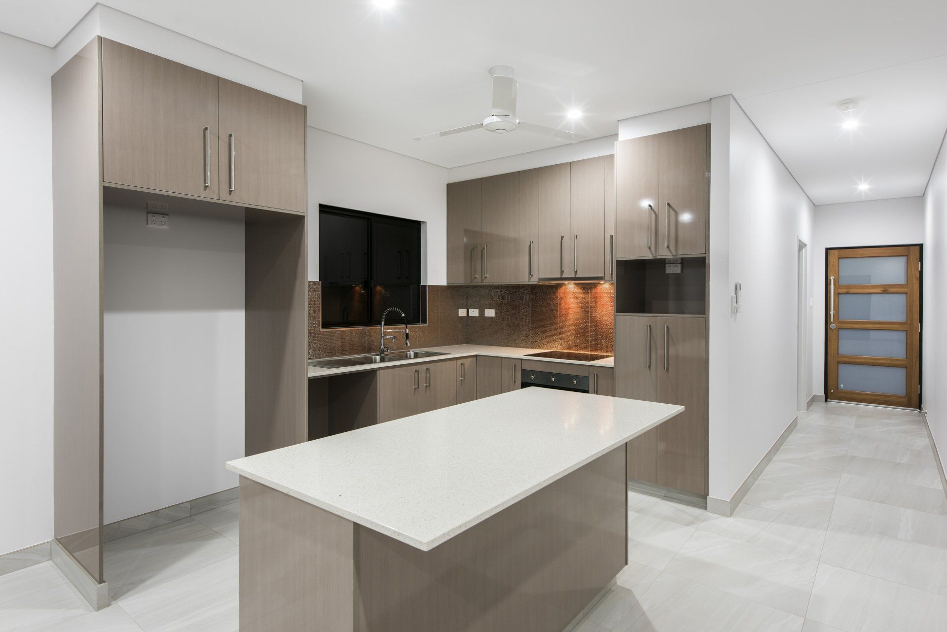 A kitchen with a large island in the middle of it