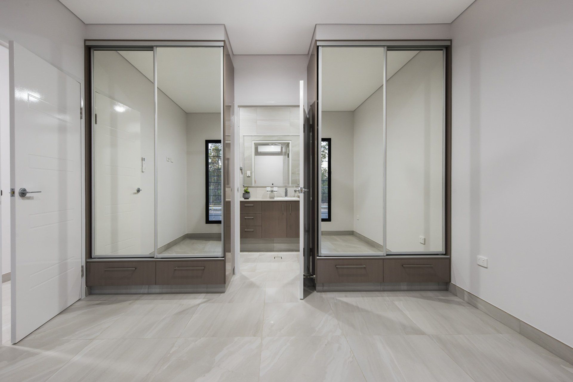 An empty room with sliding glass doors and a bathroom.