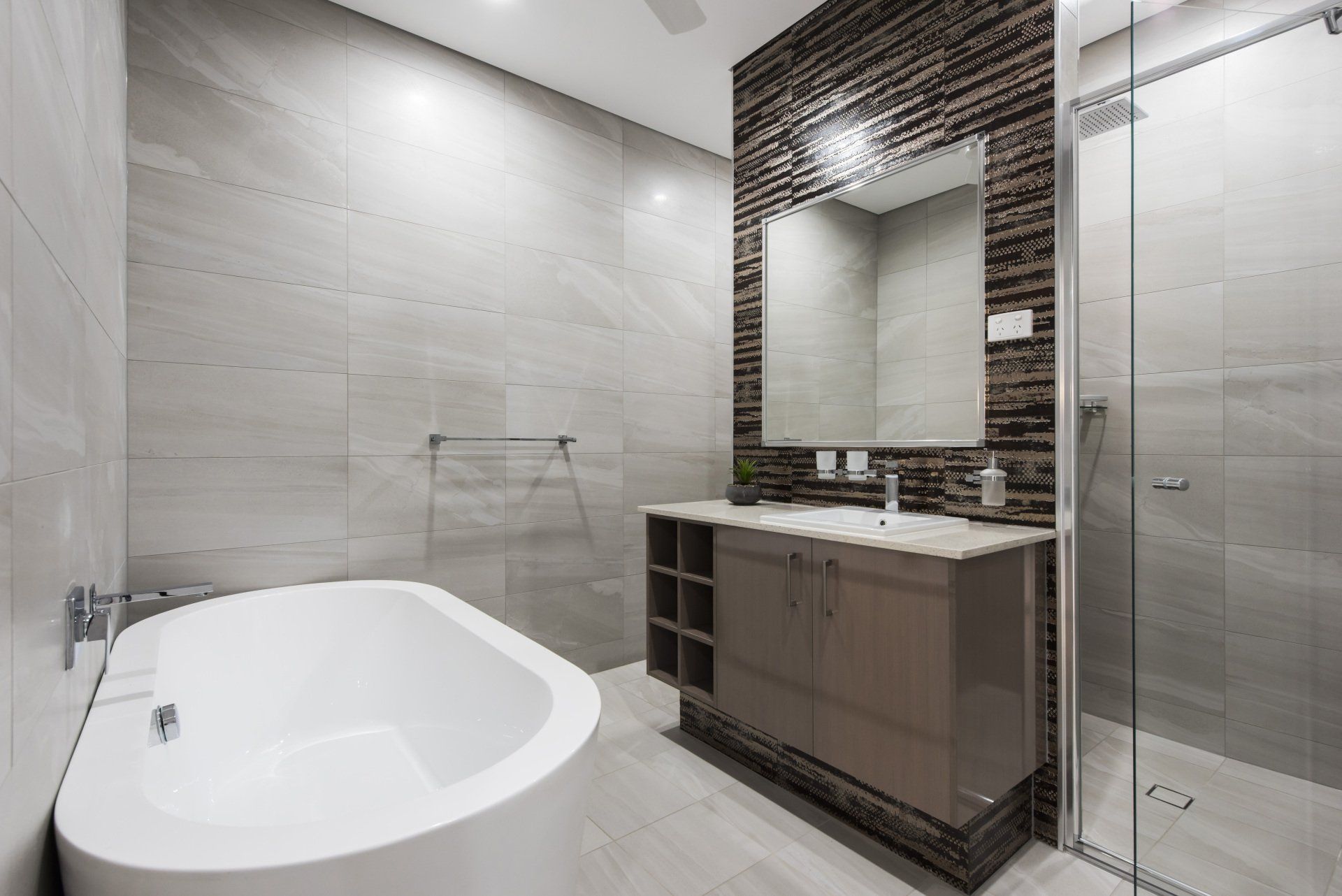 A bathroom with a tub , sink , mirror and walk in shower.