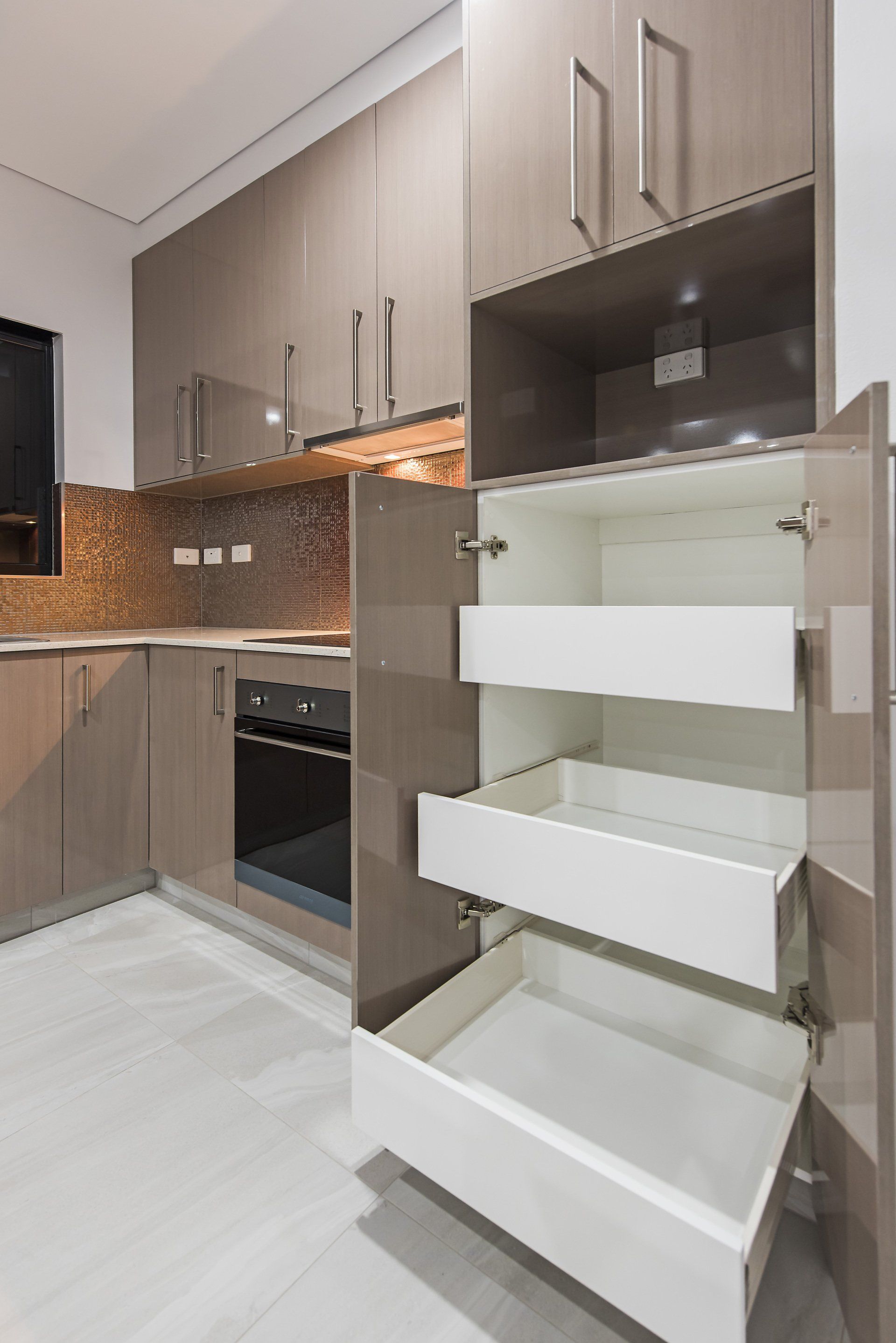 A kitchen with a lot of drawers and cabinets.