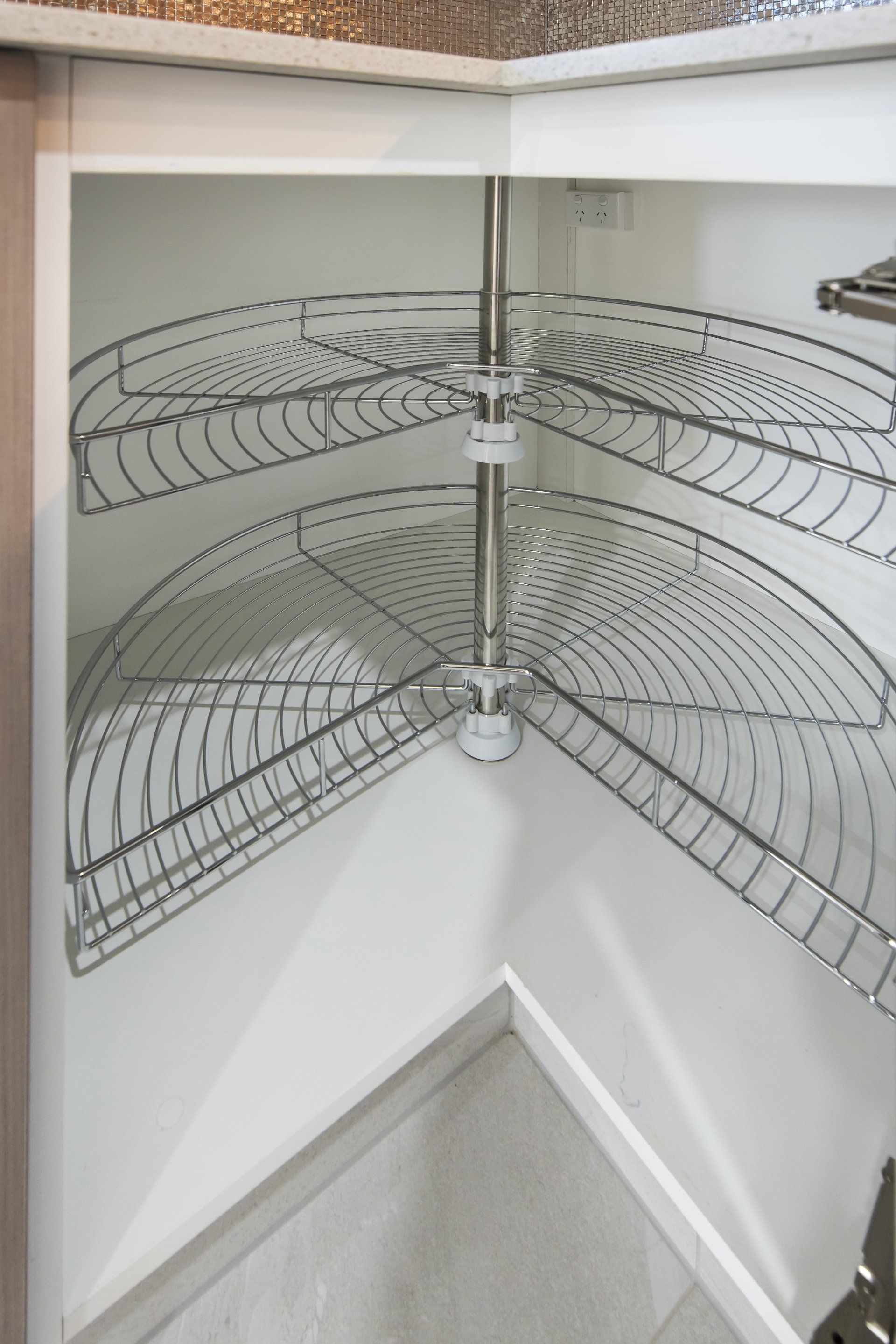 A close up of a corner shelf in a kitchen