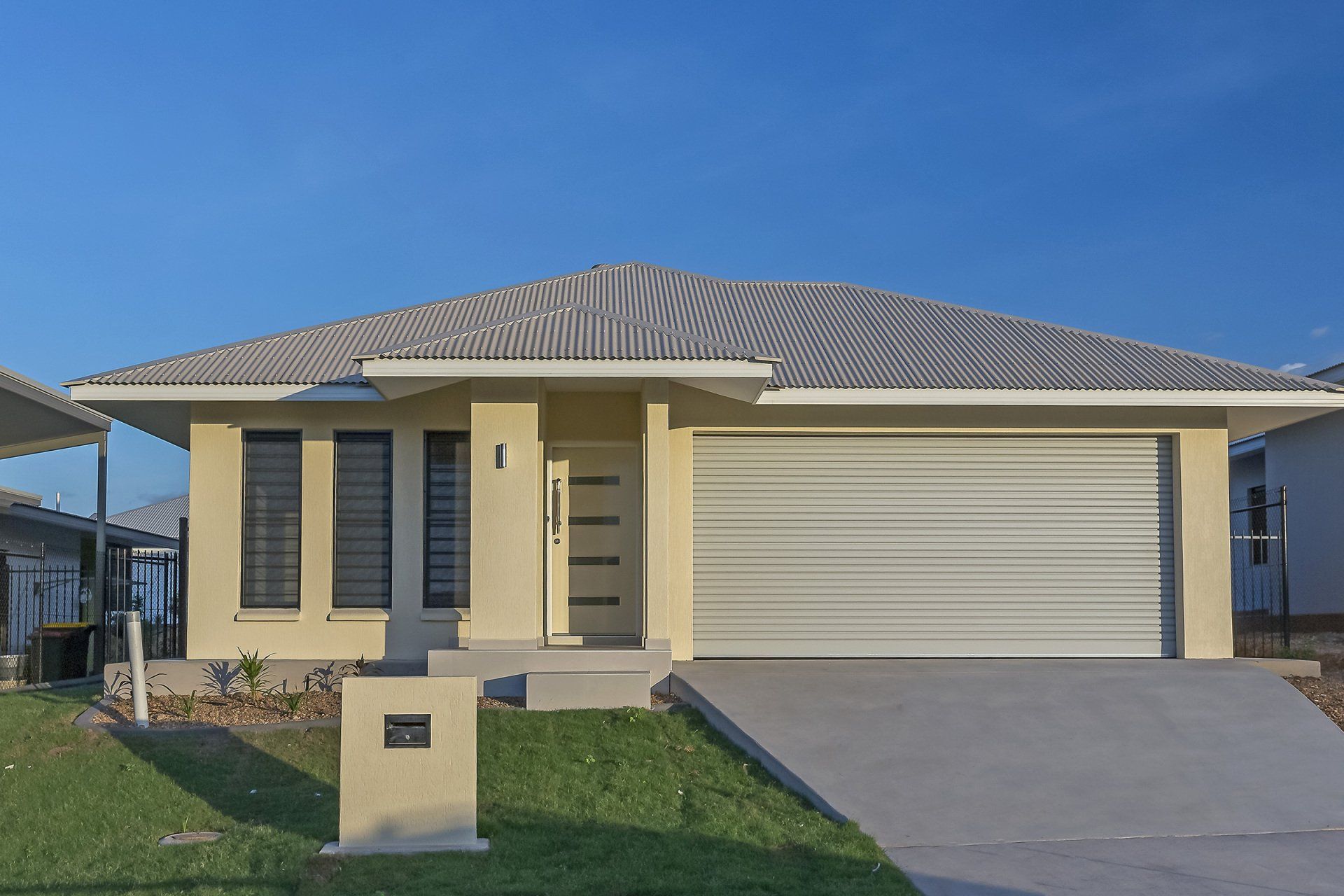 The front of a house with a white garage door