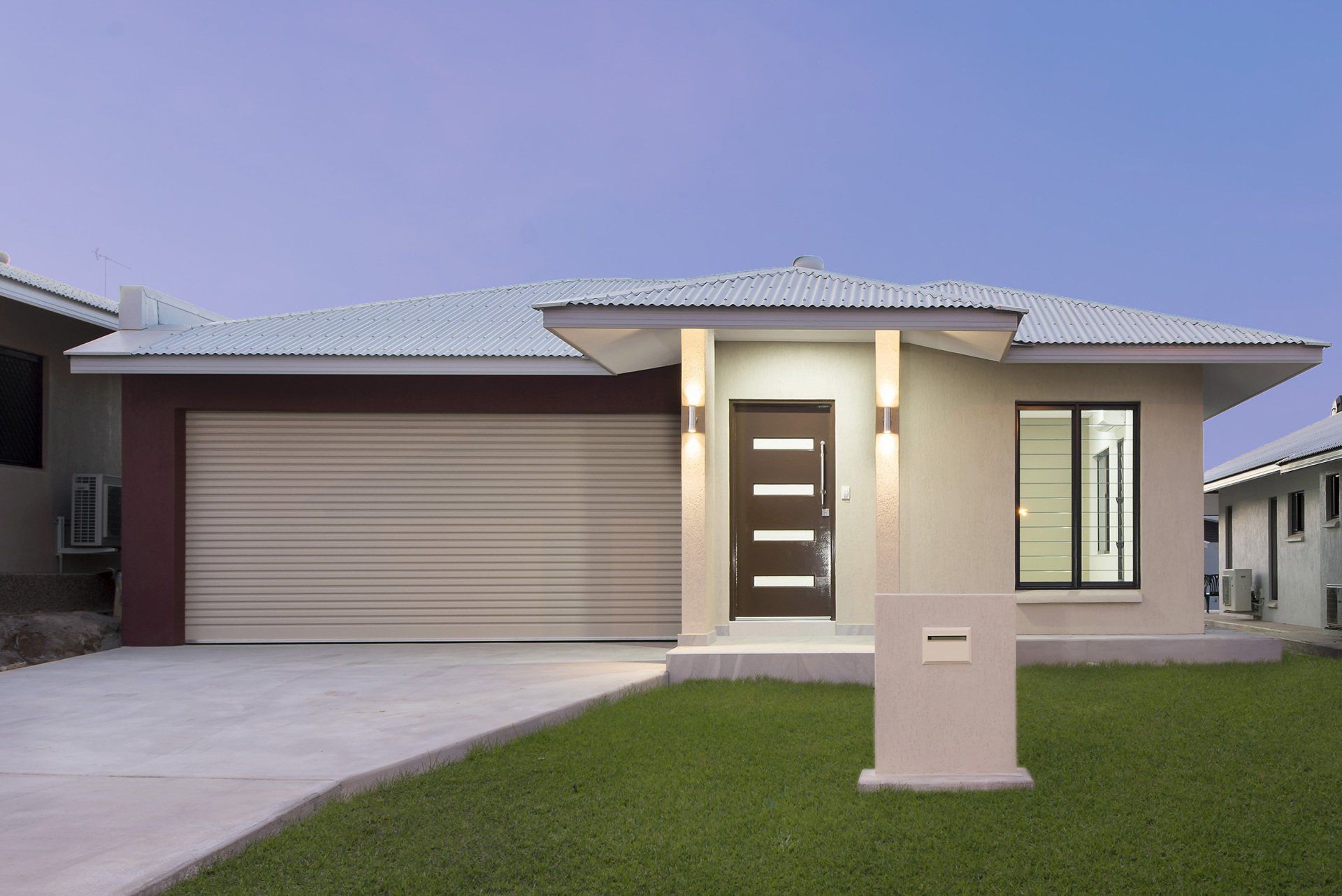The front of a house with a brown door