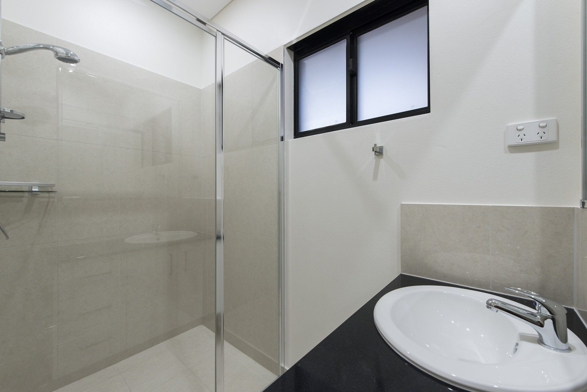 A bathroom with a sink and a walk in shower