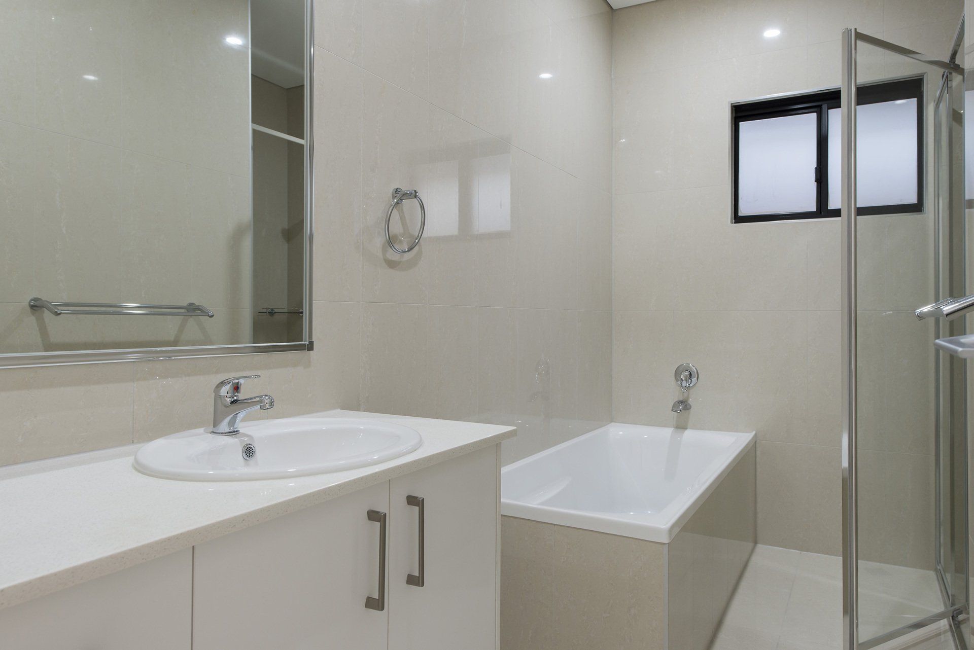 A bathroom with a sink , tub and shower.