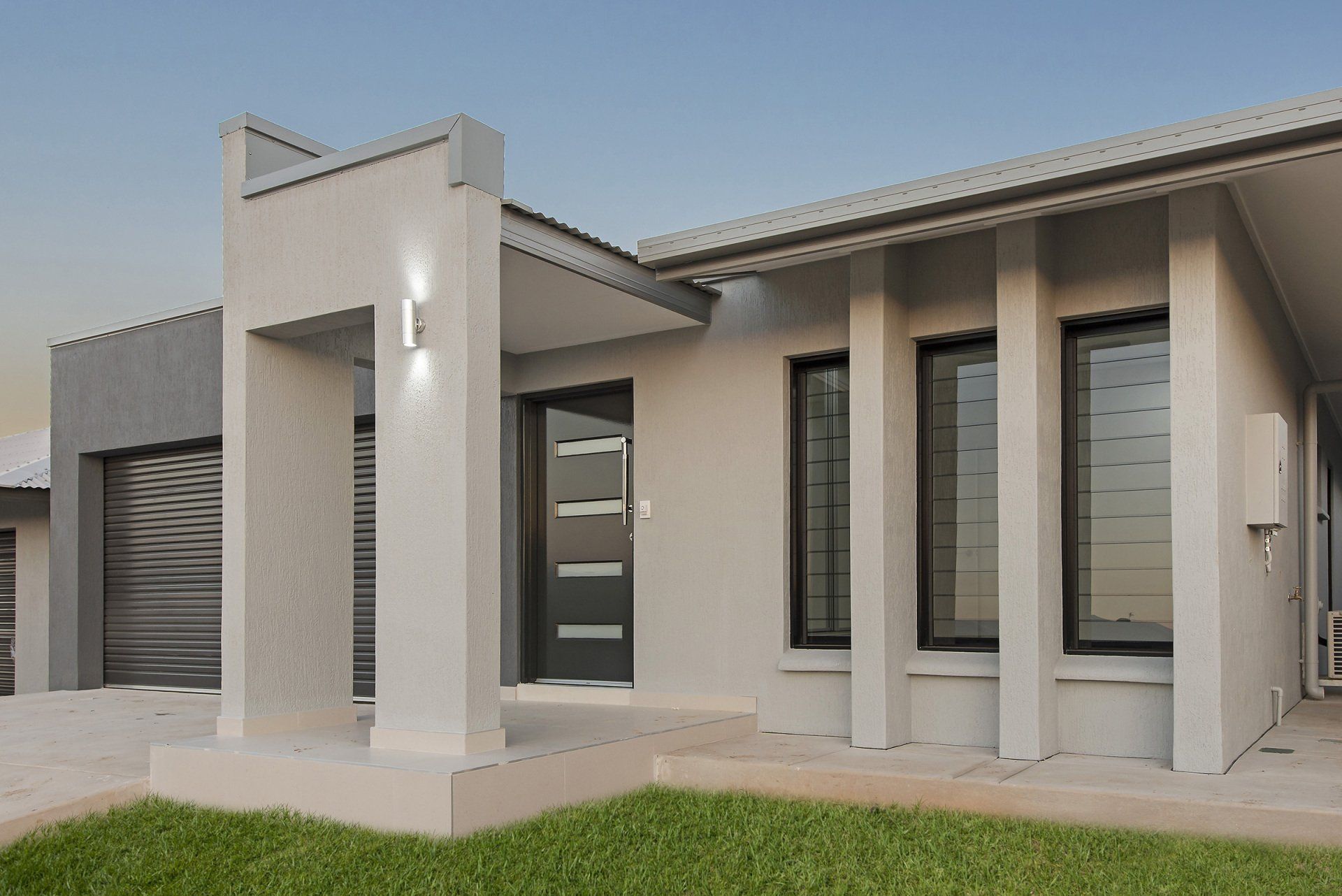 A white house with a black door and windows
