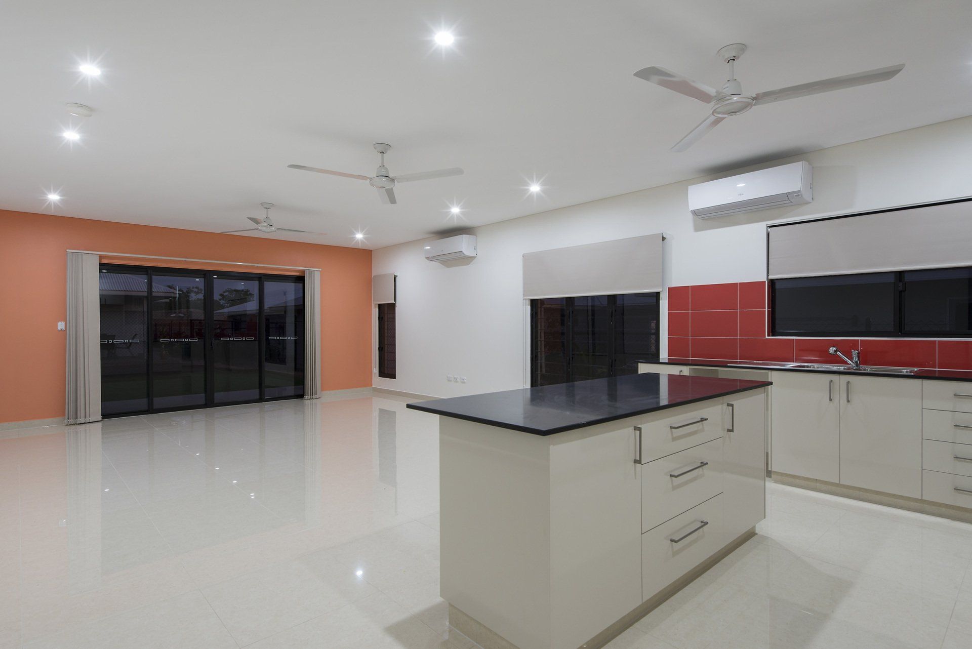 An empty kitchen with a large island in the middle