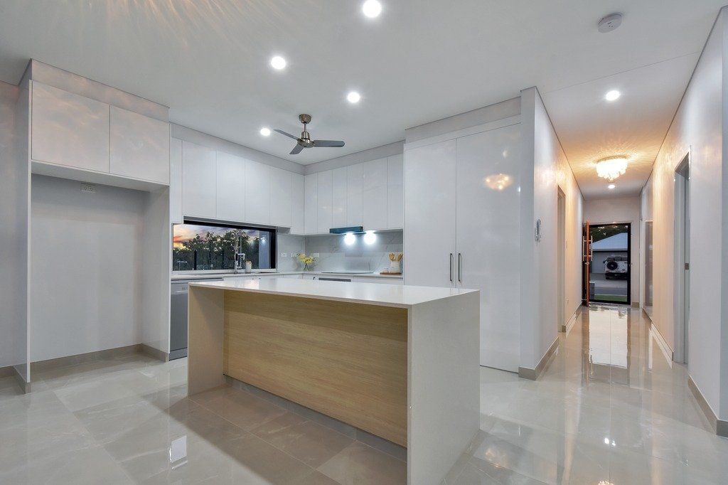 A kitchen with a large island and a ceiling fan