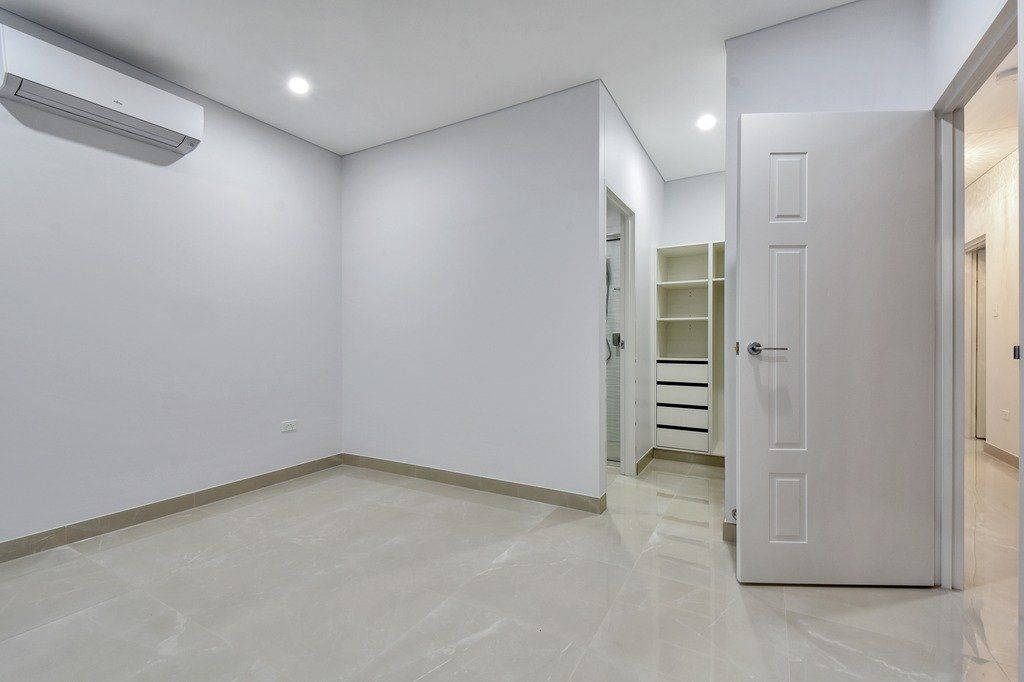 An empty room with white walls and a door.