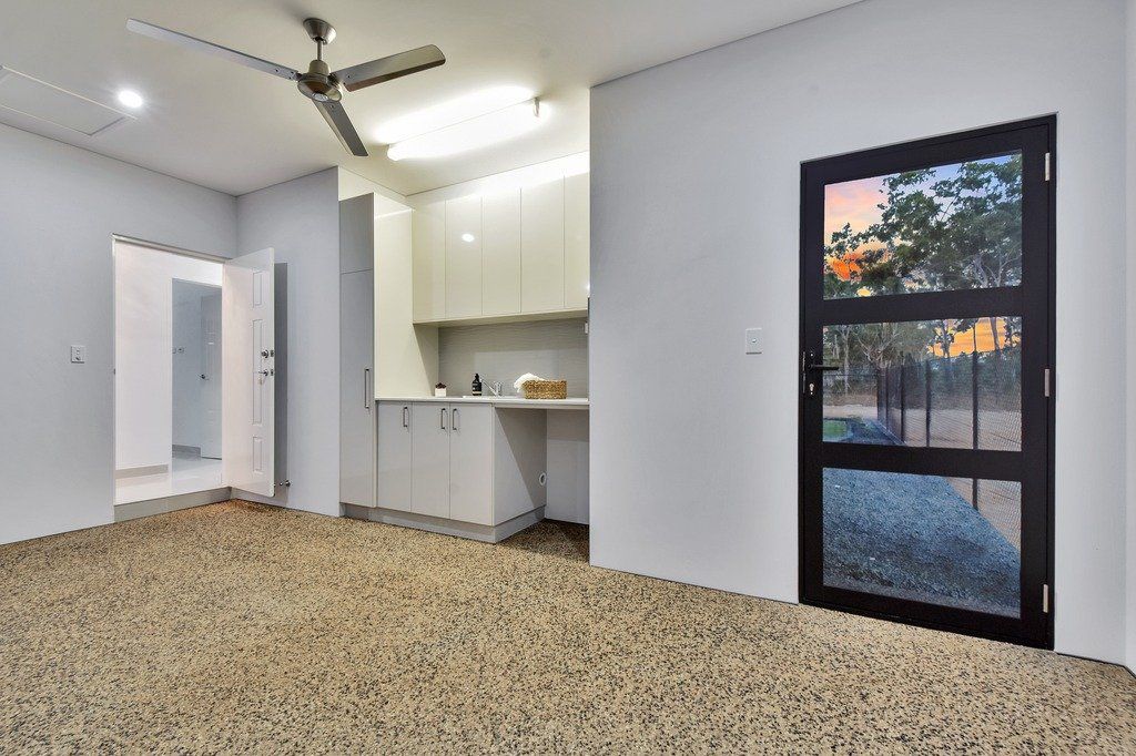 An empty room with a ceiling fan and a window.