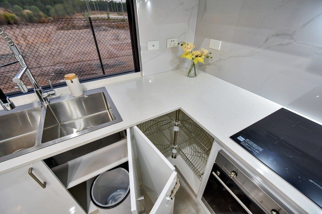 A kitchen with a sink and a stove top oven