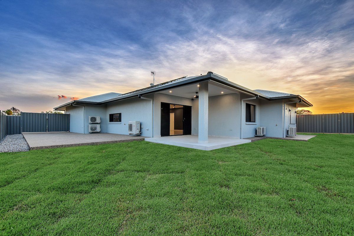 A house with a large lawn in front of it