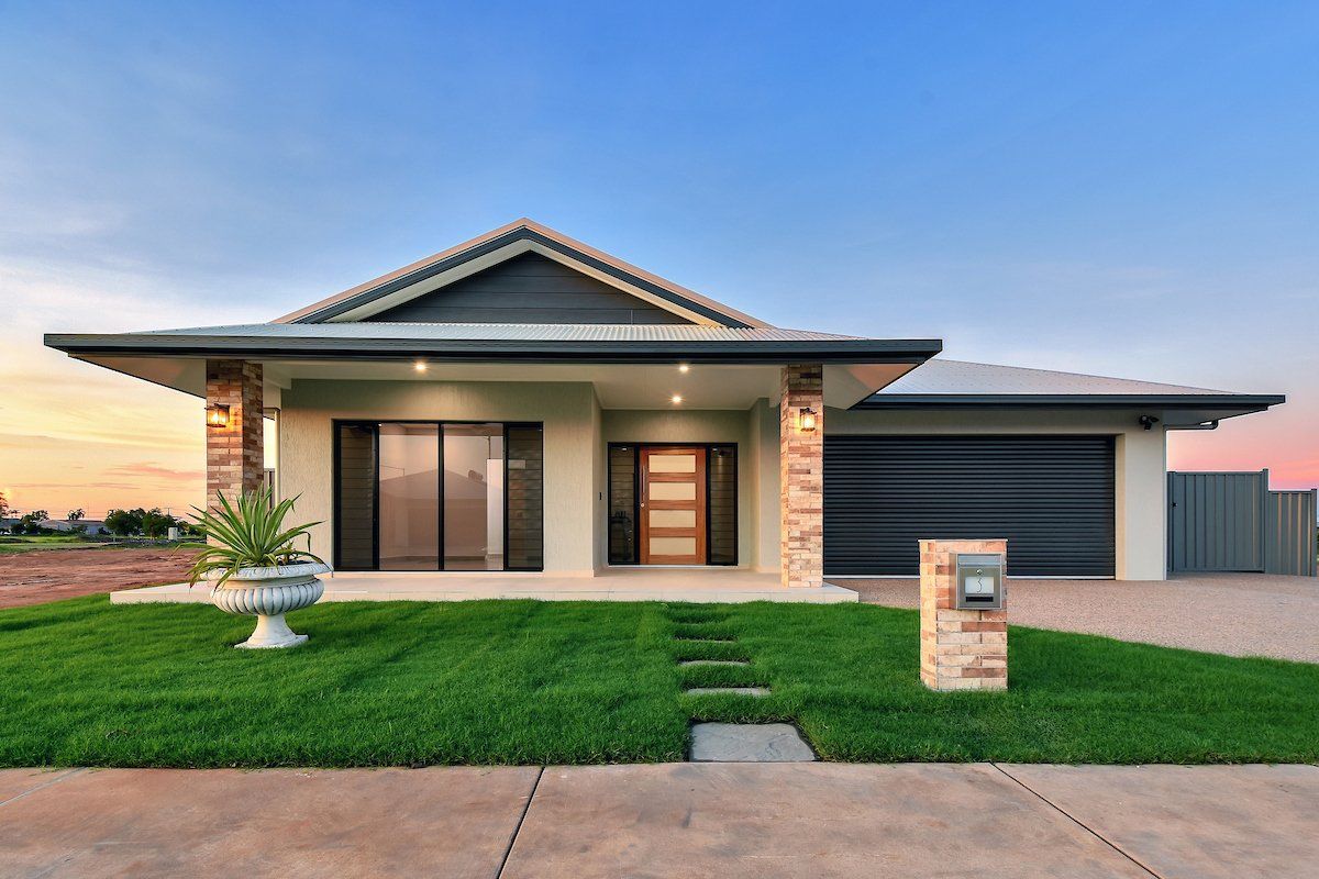 A large house with a lush green lawn in front of it