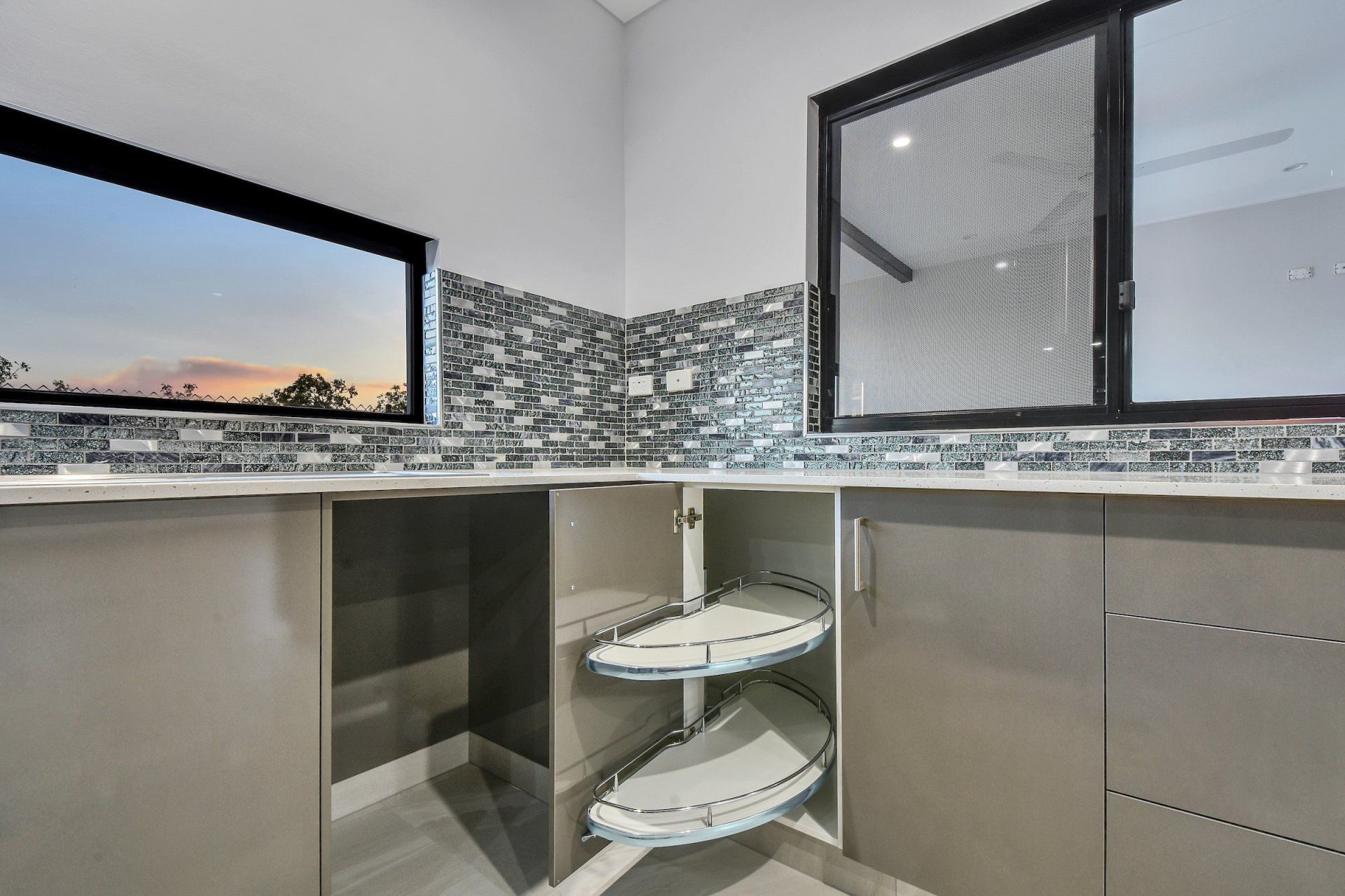 A kitchen with stainless steel cabinets and a sliding glass door.