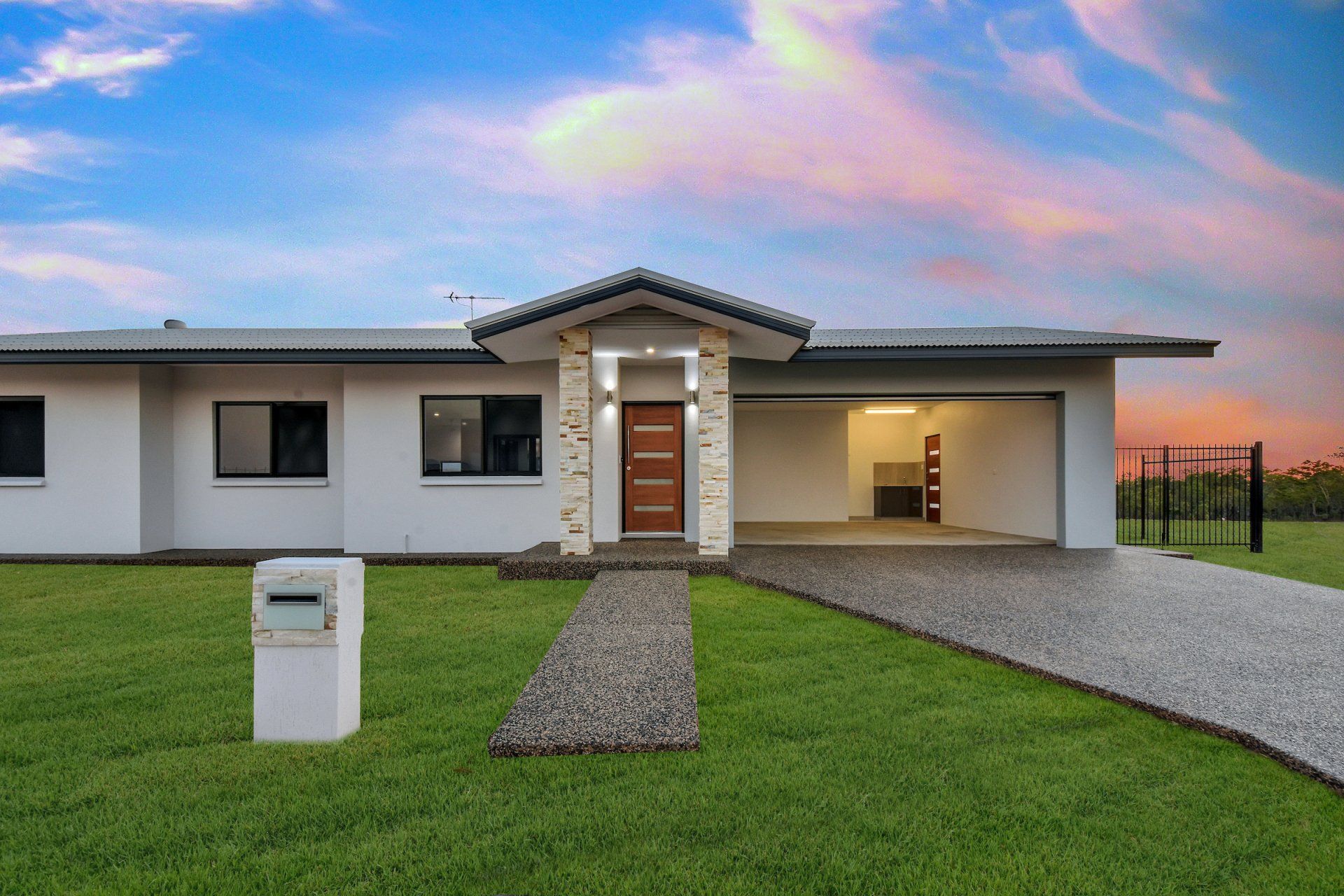 A white house with a mailbox in front of it