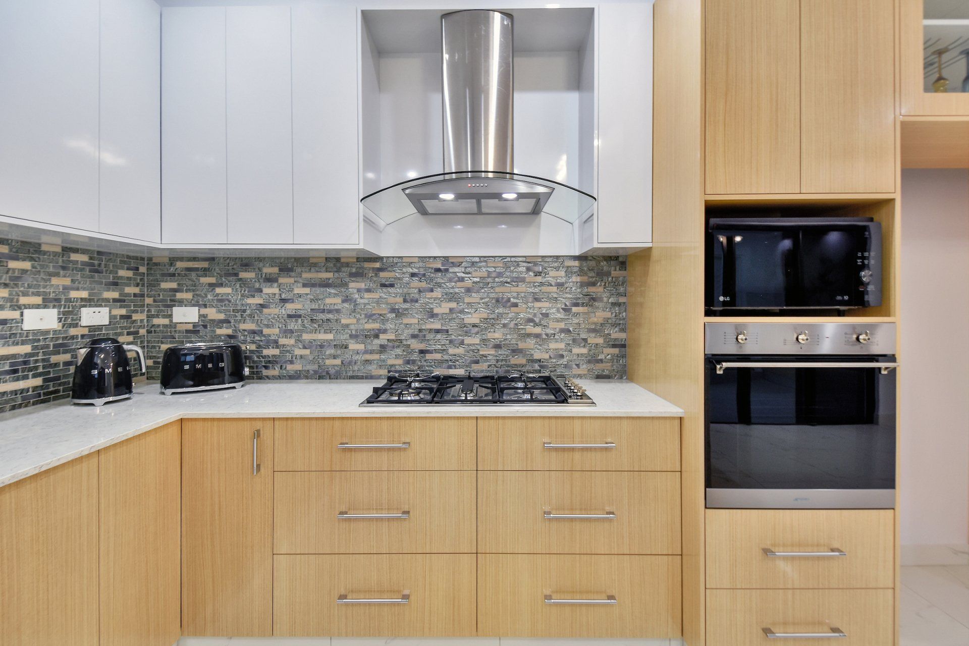 A kitchen with wooden cabinets and stainless steel appliances