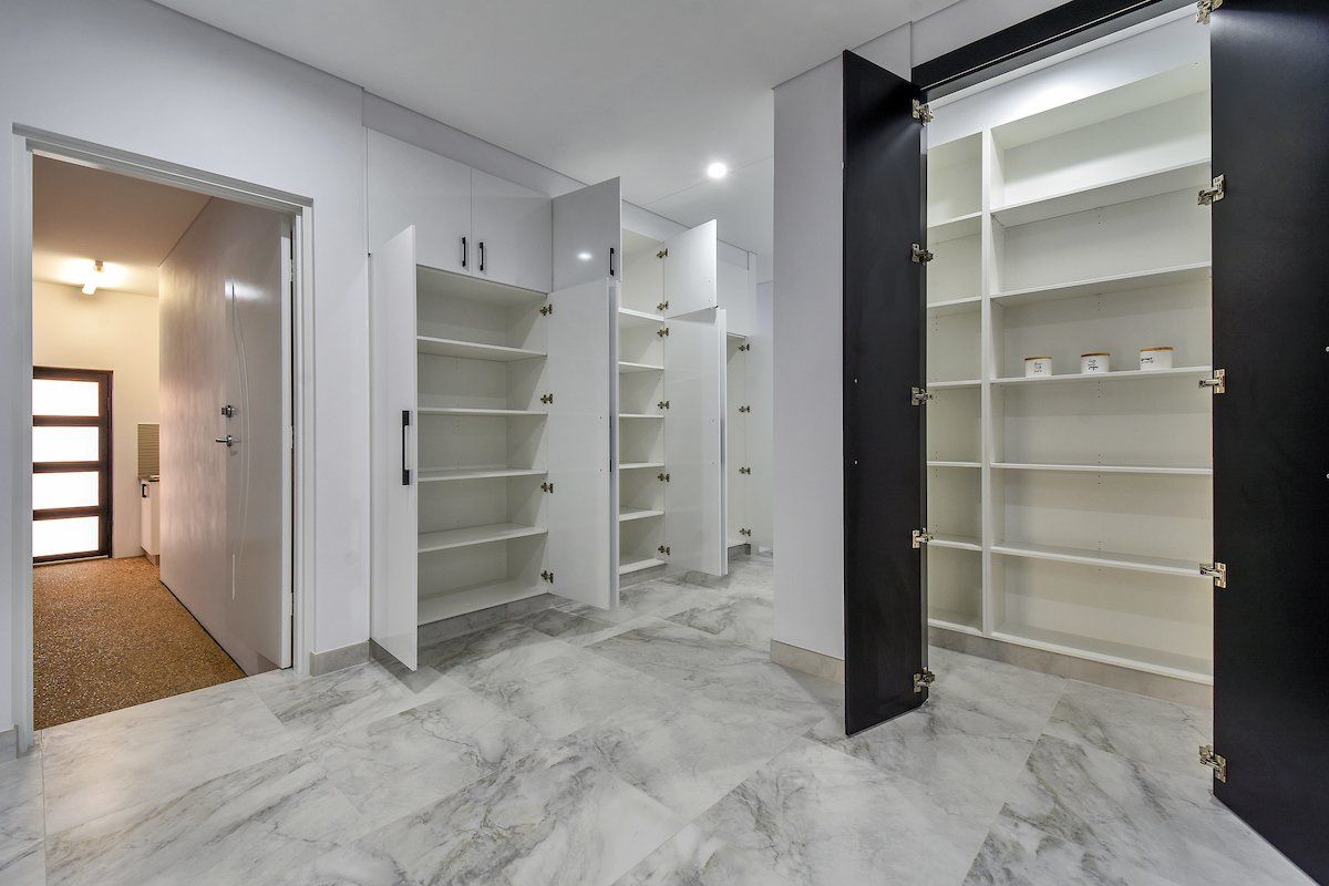 A room with a lot of shelves and cabinets in it