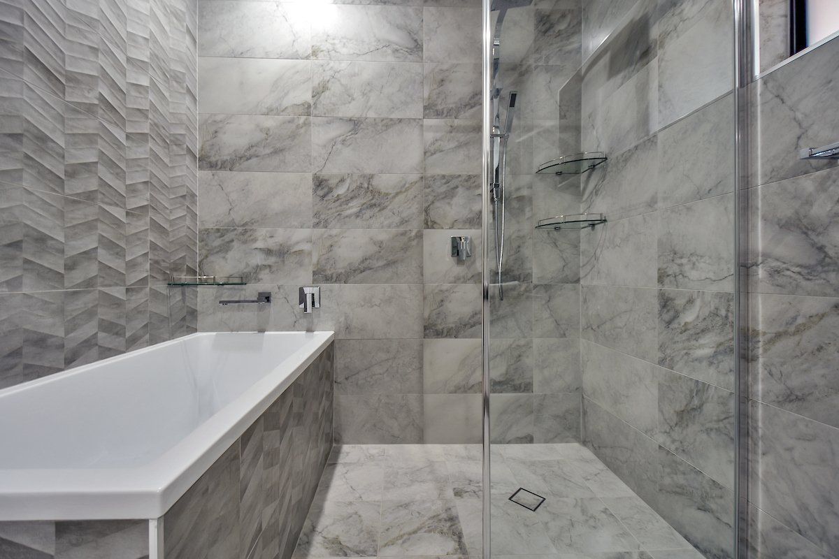 A bathroom with a bathtub and a walk in shower.