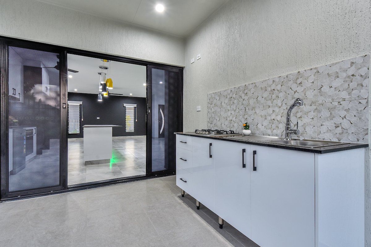 A kitchen with sliding glass doors and a sink