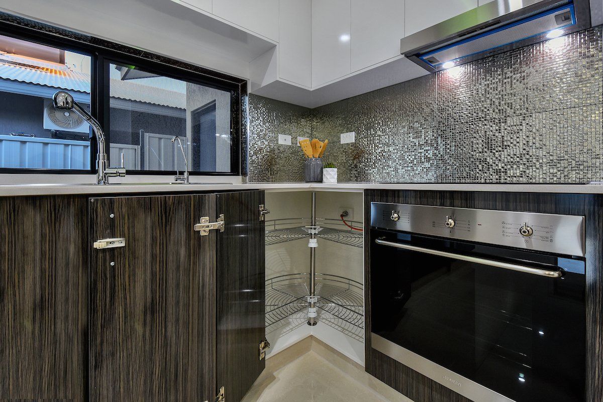 A kitchen with a sink , stove , and oven.