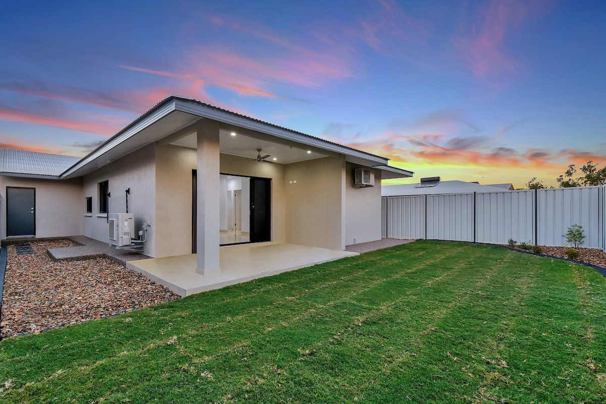 A house with a large lawn in front of it.