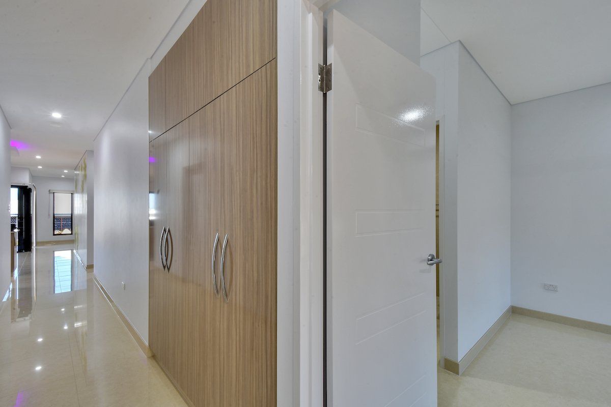 A hallway with a closet and a door in a house.