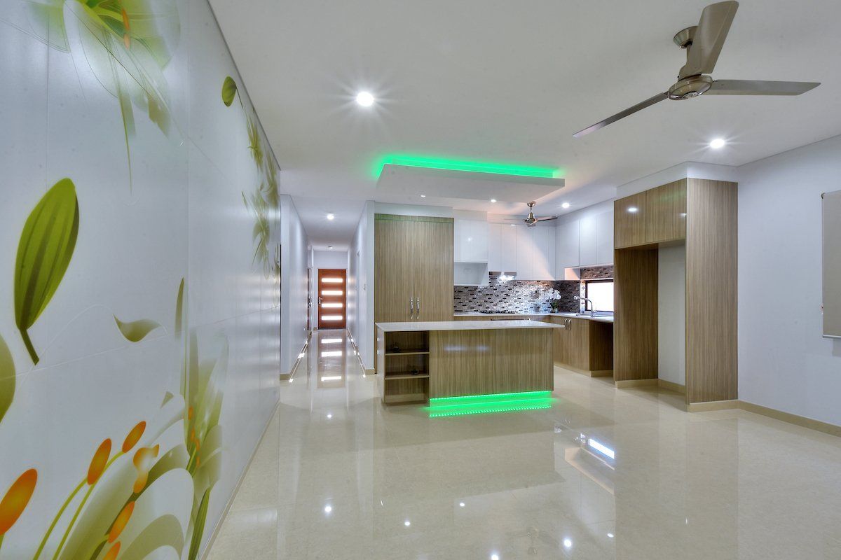 A kitchen with a green light on the ceiling