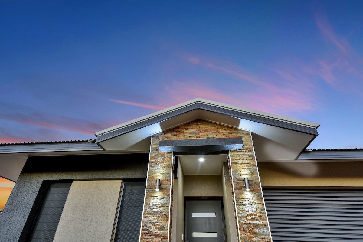 The front of a house with a blue sky in the background
