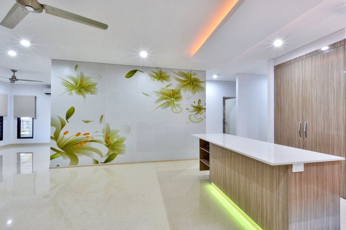 A living room with a large floral wall mural and a ceiling fan.