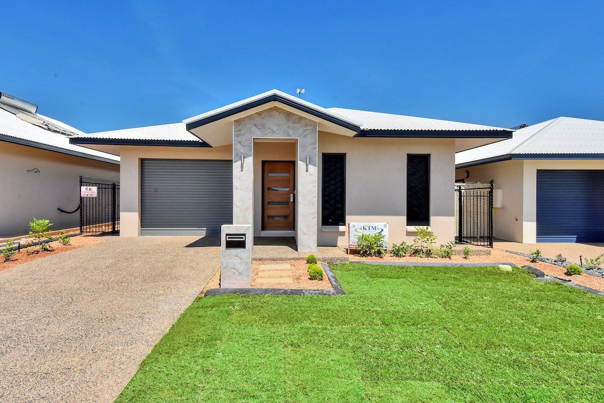 A house with a large lawn in front of it.