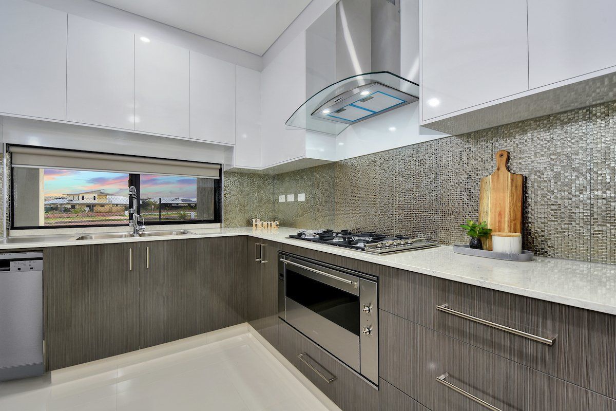 A kitchen with stainless steel appliances and white cabinets