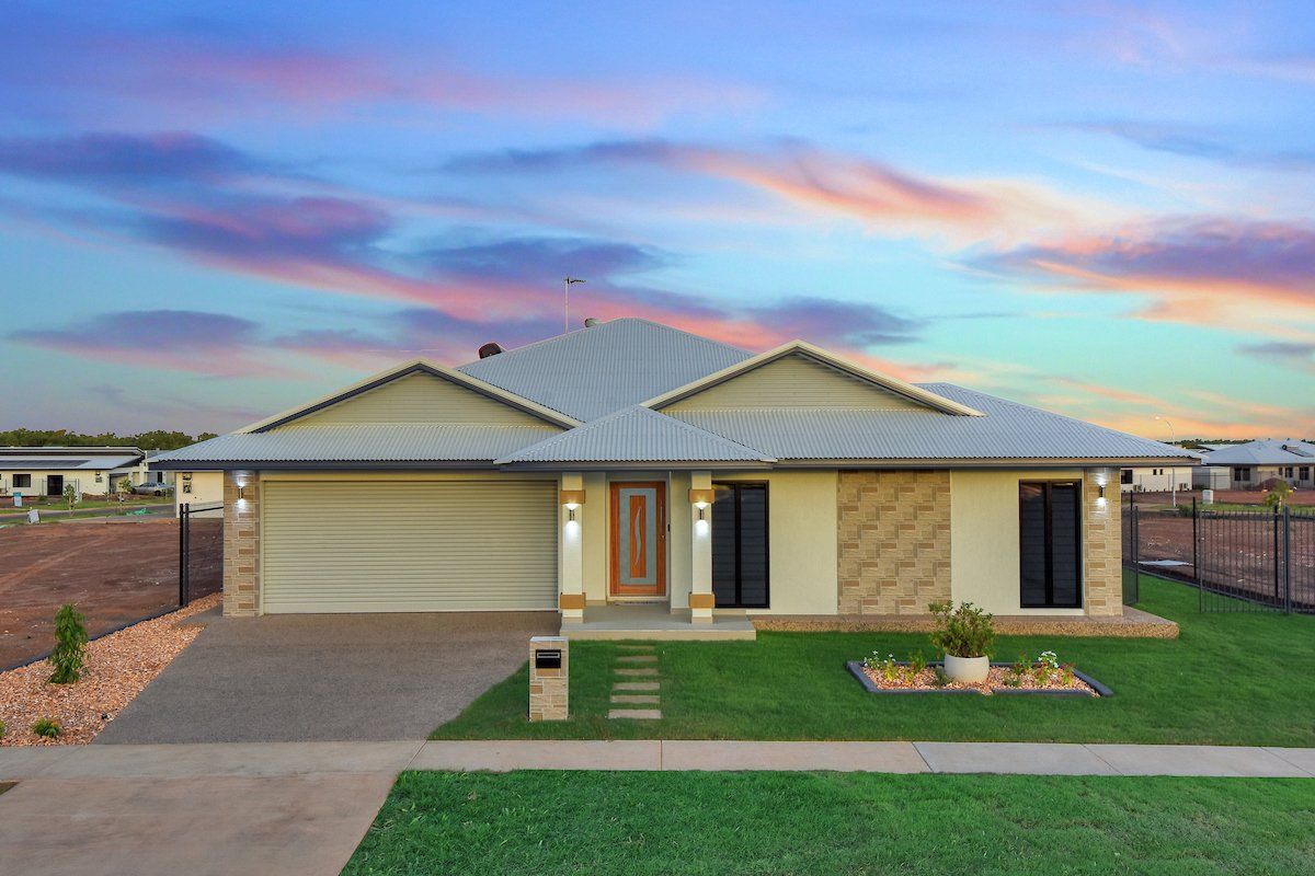 A large house with a large lawn in front of it.