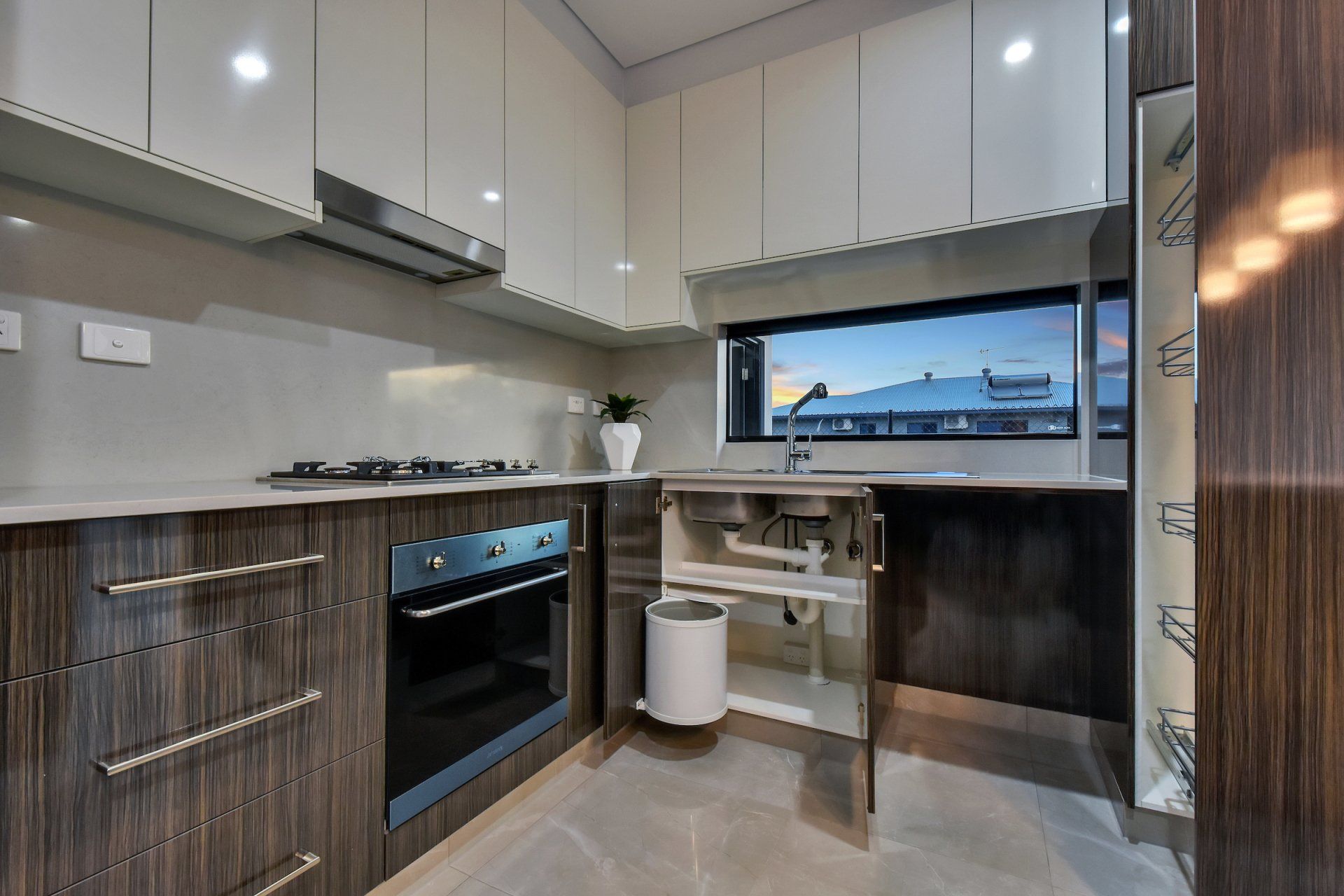A kitchen with stainless steel appliances and wooden cabinets