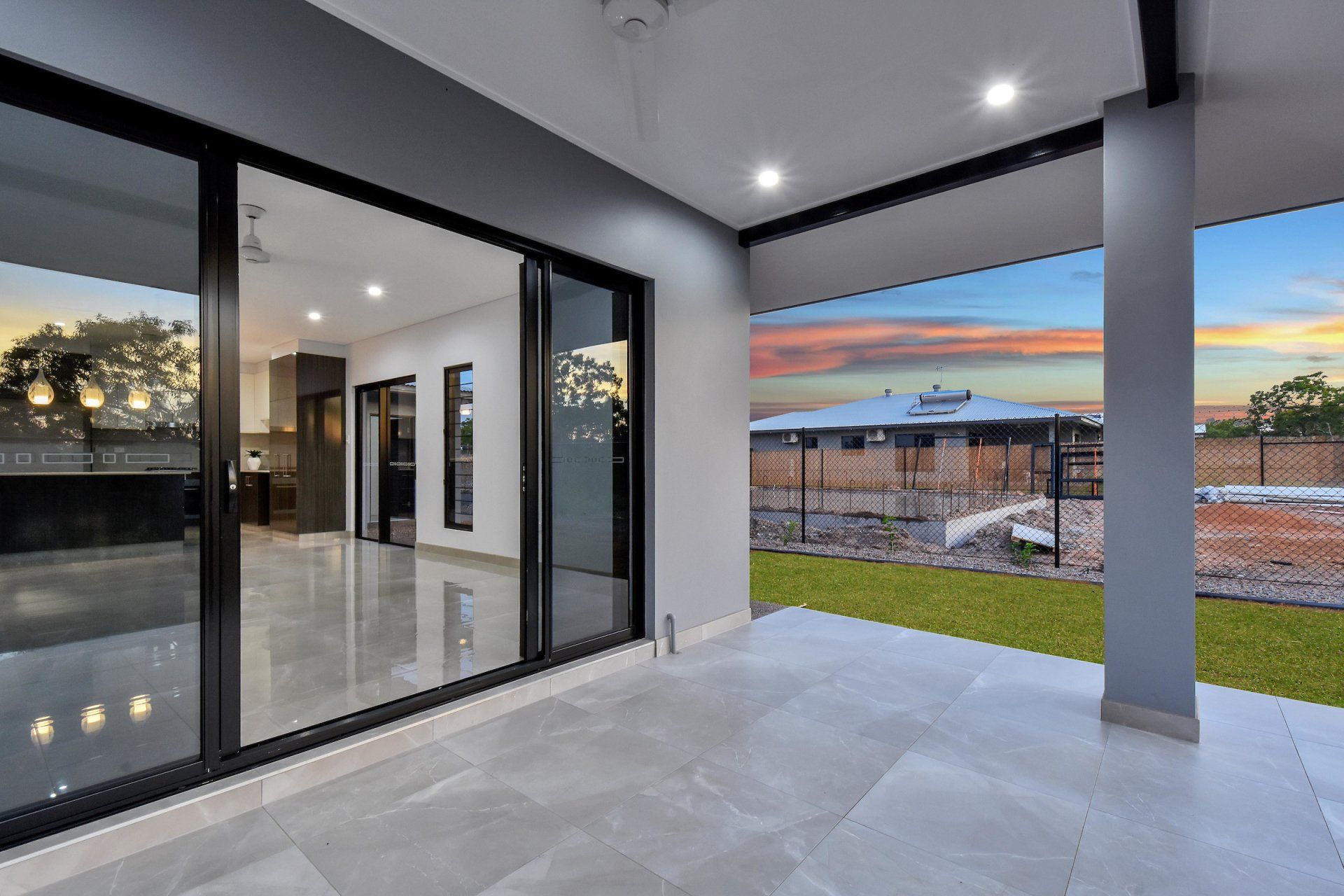 A large sliding glass door is open to a patio in a house.