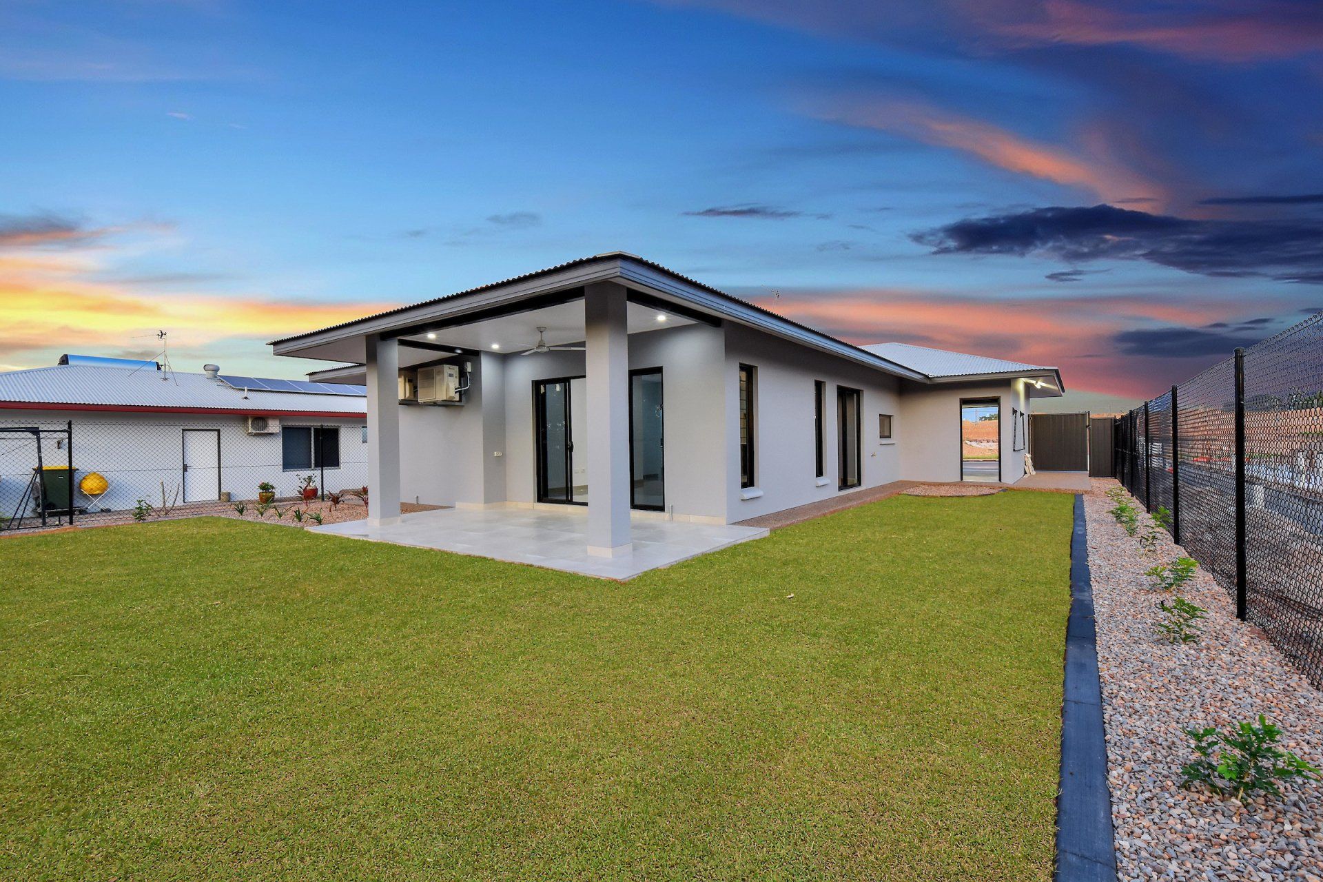 A house with a large lawn in front of it.