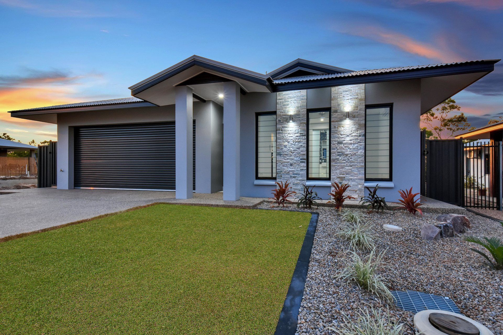 A large house with a garage and a lot of windows
