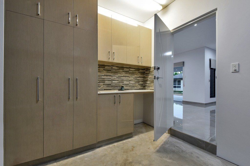 A kitchen with lots of cabinets and a door that is open