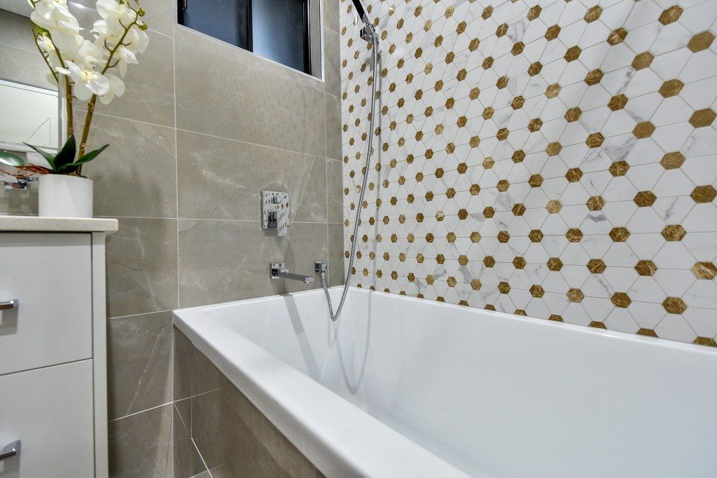 A bathroom with a bathtub and a shower.