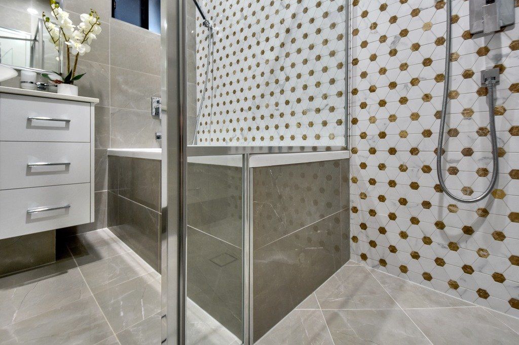 A bathroom with a walk in shower and a bathtub.