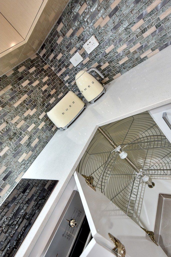 A kitchen with a stove top oven and a toaster oven