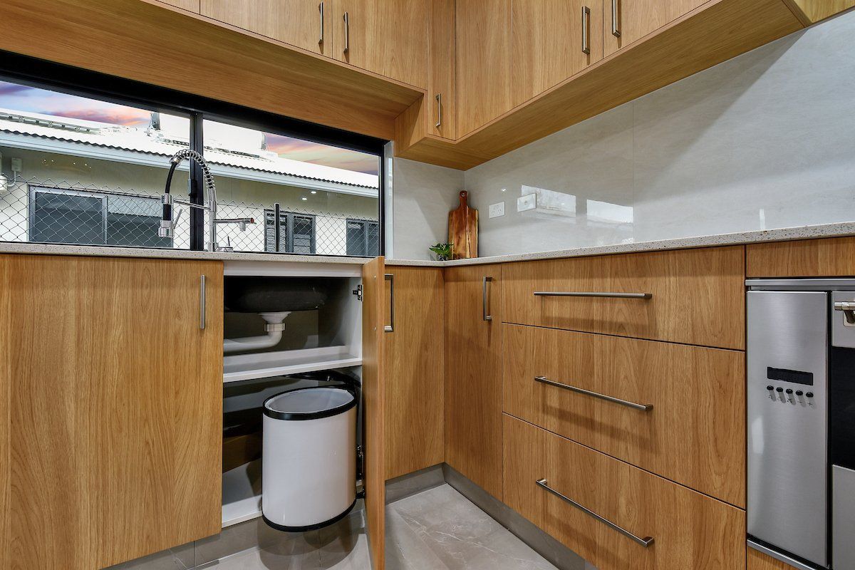 A kitchen with wooden cabinets and stainless steel appliances.
