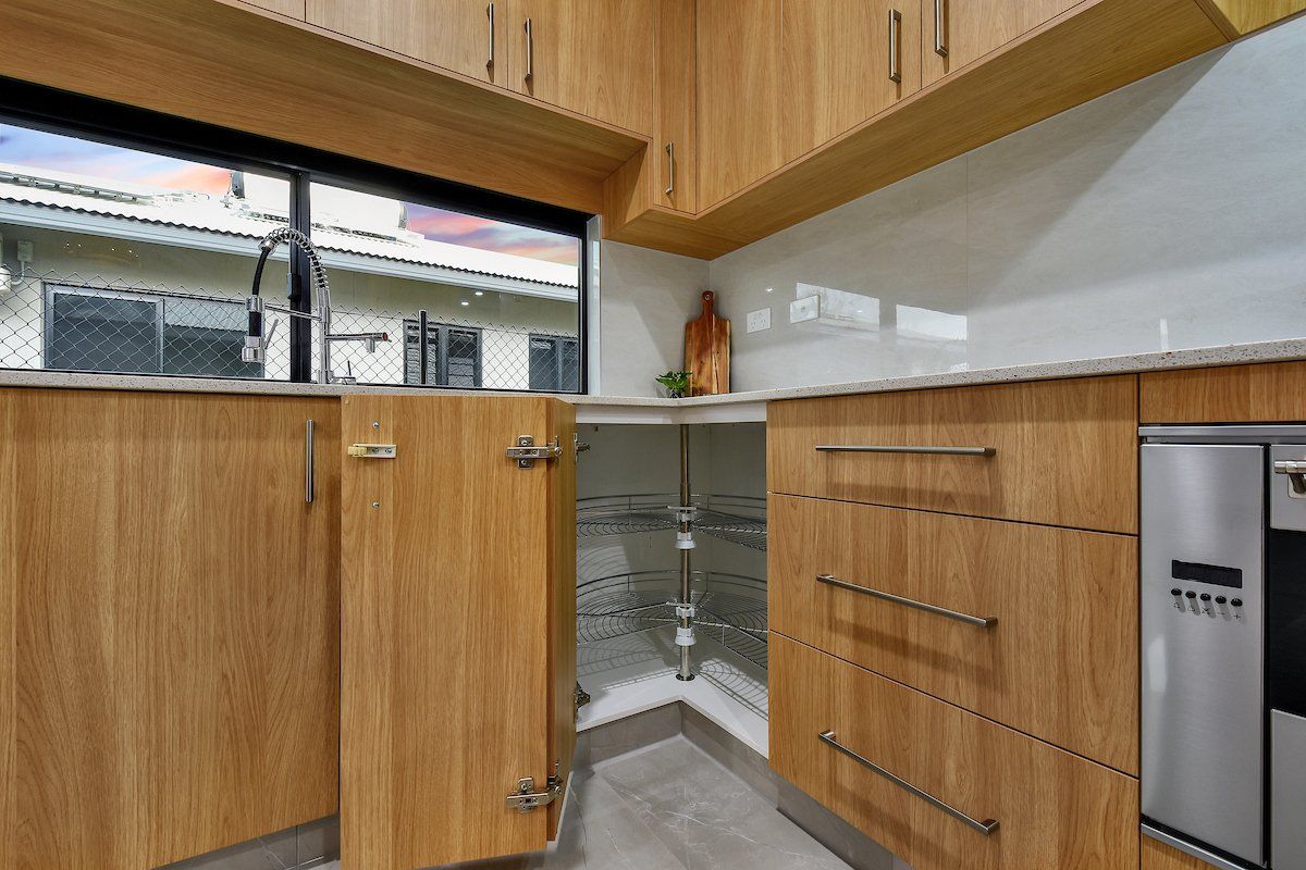 A kitchen with wooden cabinets and stainless steel appliances.