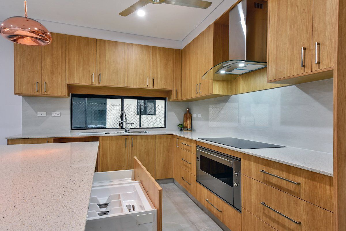 A kitchen with wooden cabinets and stainless steel appliances