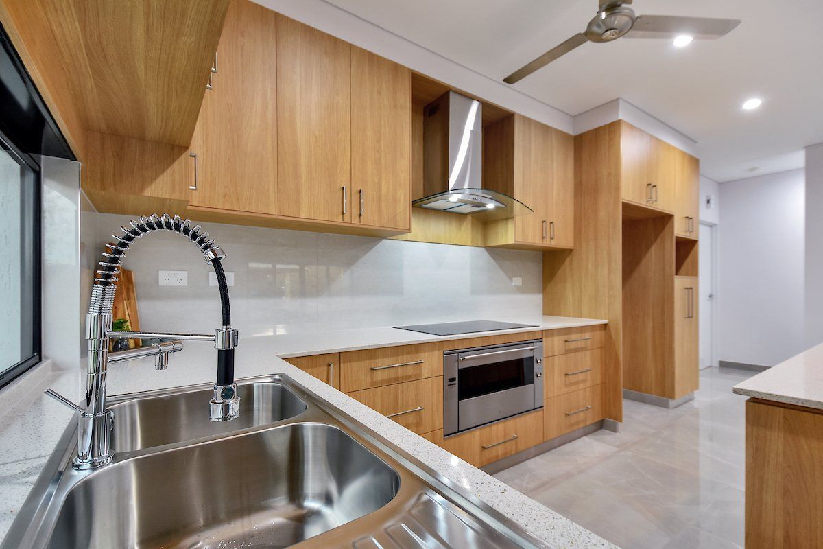 A kitchen with stainless steel appliances and wooden cabinets