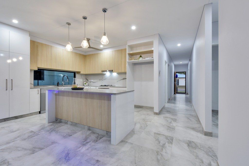A kitchen with a large island in the middle of the room.