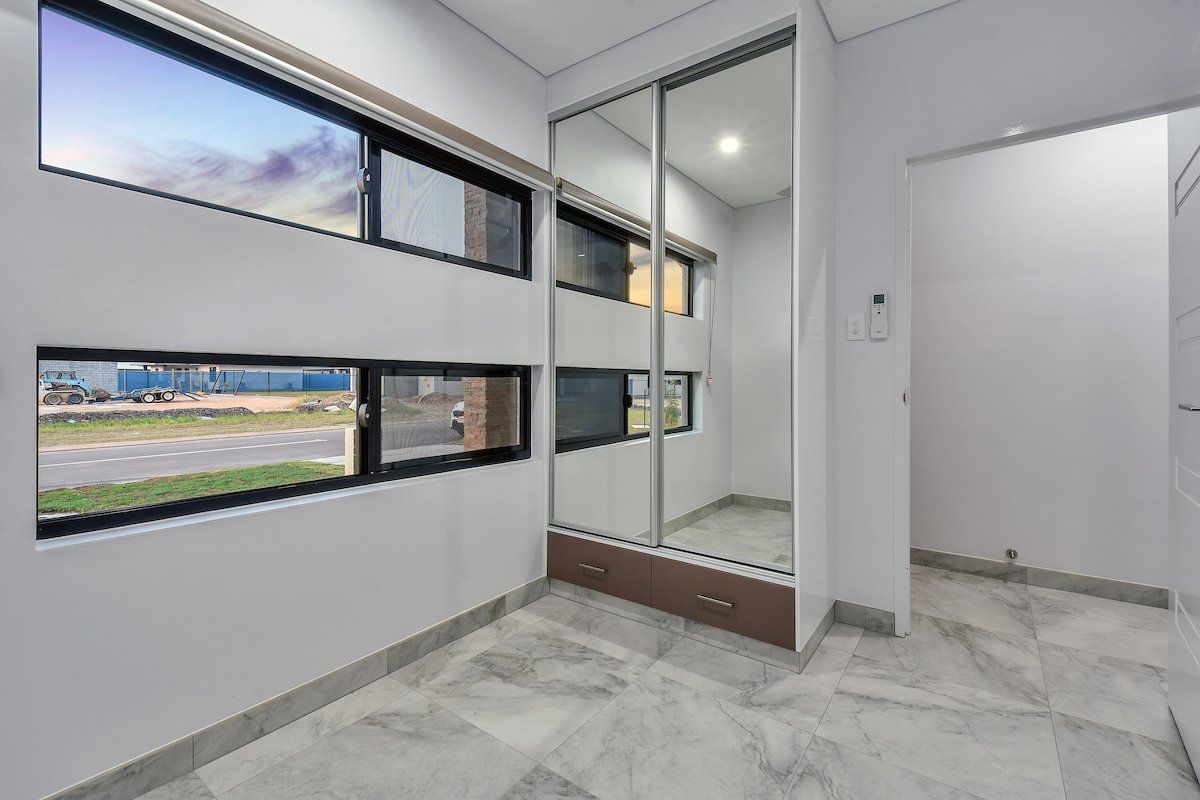 A room with a lot of windows and a sliding glass door.