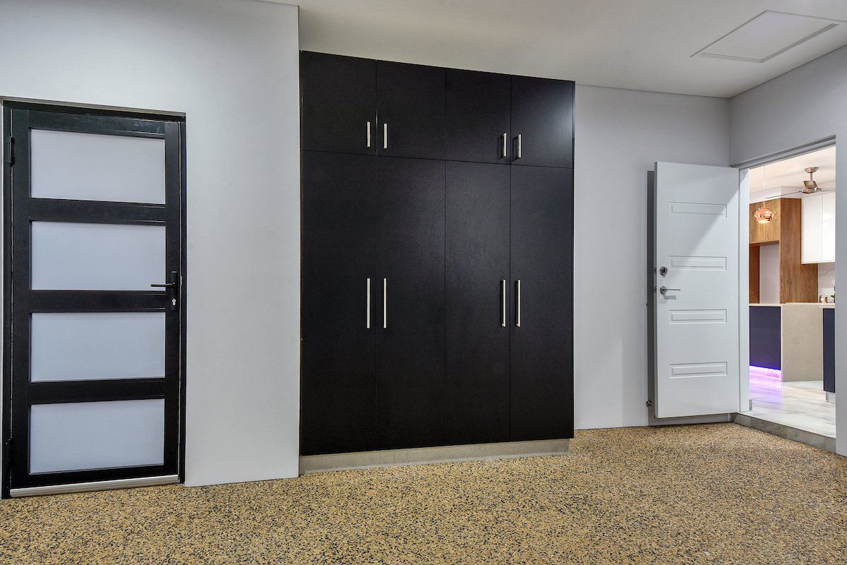 A room with a lot of cabinets and a door.