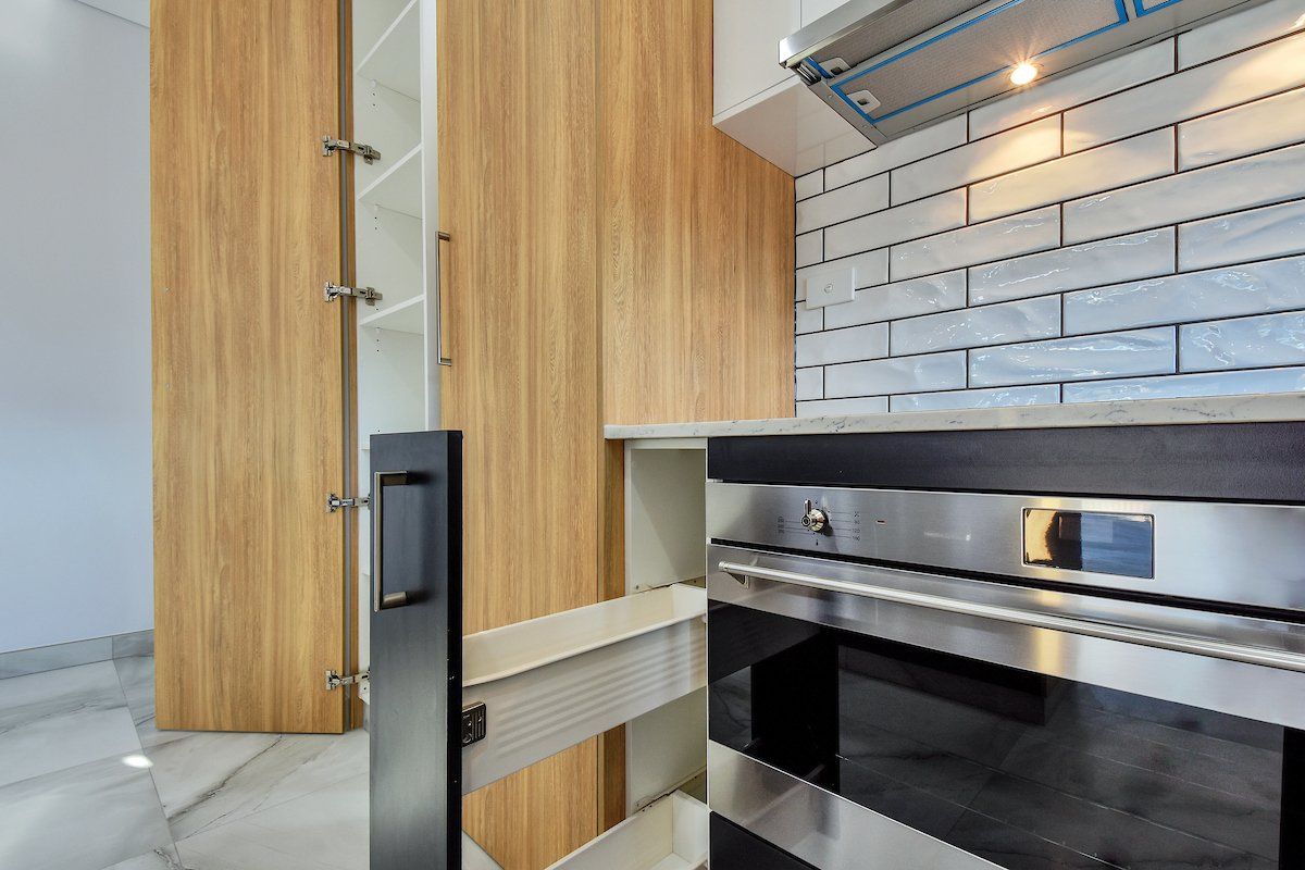A kitchen with stainless steel appliances and wooden cabinets.